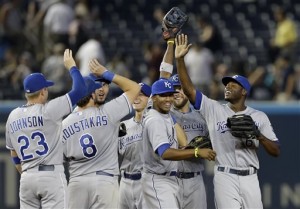 Kansas City Royals center fielder Lorenzo Cain, right, celebrates with third baseman Mike Moustakas (8) after Moustakas caught New York Yankees’ Lyle Overbay’s ninth-inning pop-up for the final out in the Royals’ 3-1 victory Tuesday in New York. (AP Photo/Kathy Willens)
