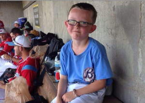 9-year old Liberal bat boy Kaiser Carlile in the Bee Jays dugout at Larks Park in mid July. (Courtesy Liberal Bee Jays)