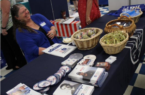 Photo by Dave Ranney Marcy Bilymsky, a suicide prevention worker with the Veterans Administration Eastern Kansas Health Care System, mans an information booth during a system-sponsored mental health summit Friday at the Scottish Rite Center in Topeka. 