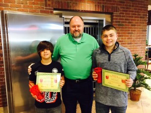 Bank VI President Tom Wilbur presents Tristian McDowell (left) and Austin Eaton with their Hero of the Week award