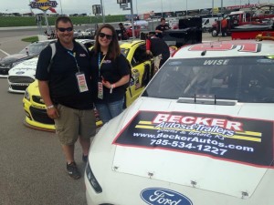 Blake and Lydia Housh next to the Becker Autos & Trailers 98 NASCAR Sprint Cup Car at Kansas Speedway in May.