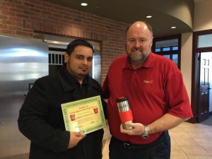 BANK VI President Tom Wilbur presents Emanuel Manwaring with his Hero of the Week award