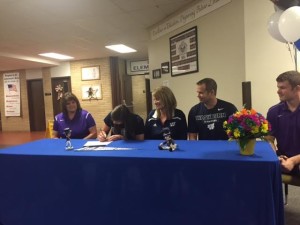Erica Montgomery (second from left) signs her National Letter of Intent to play volleyball at Washburn on Thursday at Southeast of Saline High School.