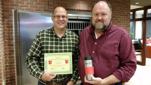 BANK VI President Tom Wilbur presents Jeff Shaw with his Hero of the Week award