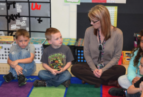 Lori Williams interacts with one of her first-grade students at Alexander Procter Elementary School. CREDIT TAMMY WORTH / HEARTLAND HEALTH MONITOR
