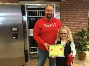 BANK VI Senior Vice President Chris Baker presents Emily Streeter with her Hero of the Week award