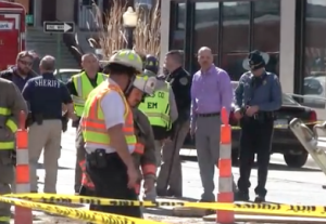 Rescue workers on the scene of a trench collapse on Main Street in downtown Hays Tuesday afternoon.