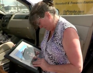 Kelly Hunt looks at a photo of her son while on a travel stop in Albuquerque-photo courtesy KRQE-TV