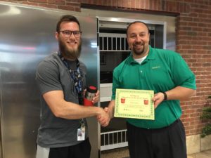 BANK VI Senior Vice President Chris Baker presents Nick Pahls with his Hero of the Week award. Nick Neuburger was not present.