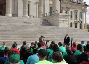 Photo by Andy Marso/KHI News Service Rep. Les Osterman, a Republican from Wichita, spoke at a March rally outside the Capitol for disability advocates seeking a delay of the state’s plan to integrate Medicaid waiver services for Kansans with disabilities. Gov. Sam Brownback’s administration will not fight a legislative directive to postpone the integration of Medicaid waiver services for Kansans with disabilities, according to an email sent Wednesday by an administration official. -