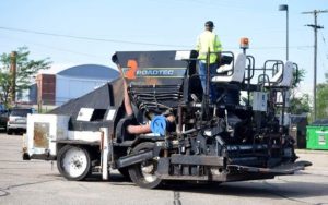 An Apac employee maneuvers the paver into its new parking place at Salina Tech. (Photos: Salina Tech)