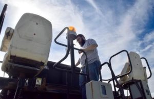 Diesel Tech instructor Gabe Winger checks out the driver positions on the paver.
