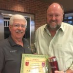 Tom Wilbur, President of Bank VI presents Dr. Doug Kempton with the Hero of the Week Award.