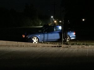 This vehicle struck a power pole and a concrete guard rail. The driver was not injured.