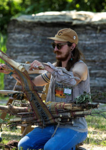 Neil Goss, with the help of Friends of the River volunteers, weave invasive species from the Smoky Hill River into beautiful art work (Photo: Salina Arts & Humanities)