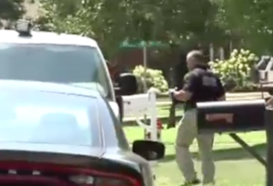 Police remove guns from the home on Thursday afternoon- photo courtesy KWCH