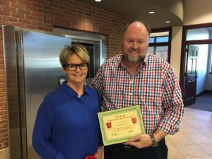 Tom Wilbur, President of BANK VI, presents Becky Patrick with her Hero of the Week Award