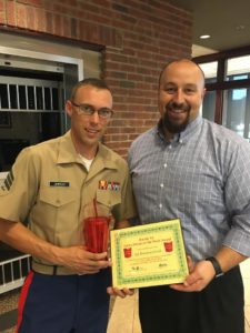 Chris Baker, BANK VI Executive Vice President and Senior Lender, presents Sgt. Brandon Uhrich with his Hero of the Week Award